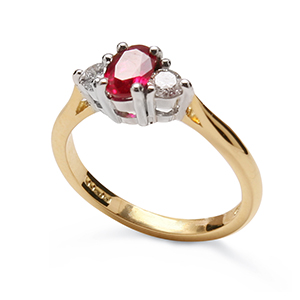 Oval ruby and brilliant cut diamond three stone