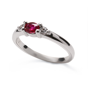 Oval ruby and brilliant cut diamond three stone